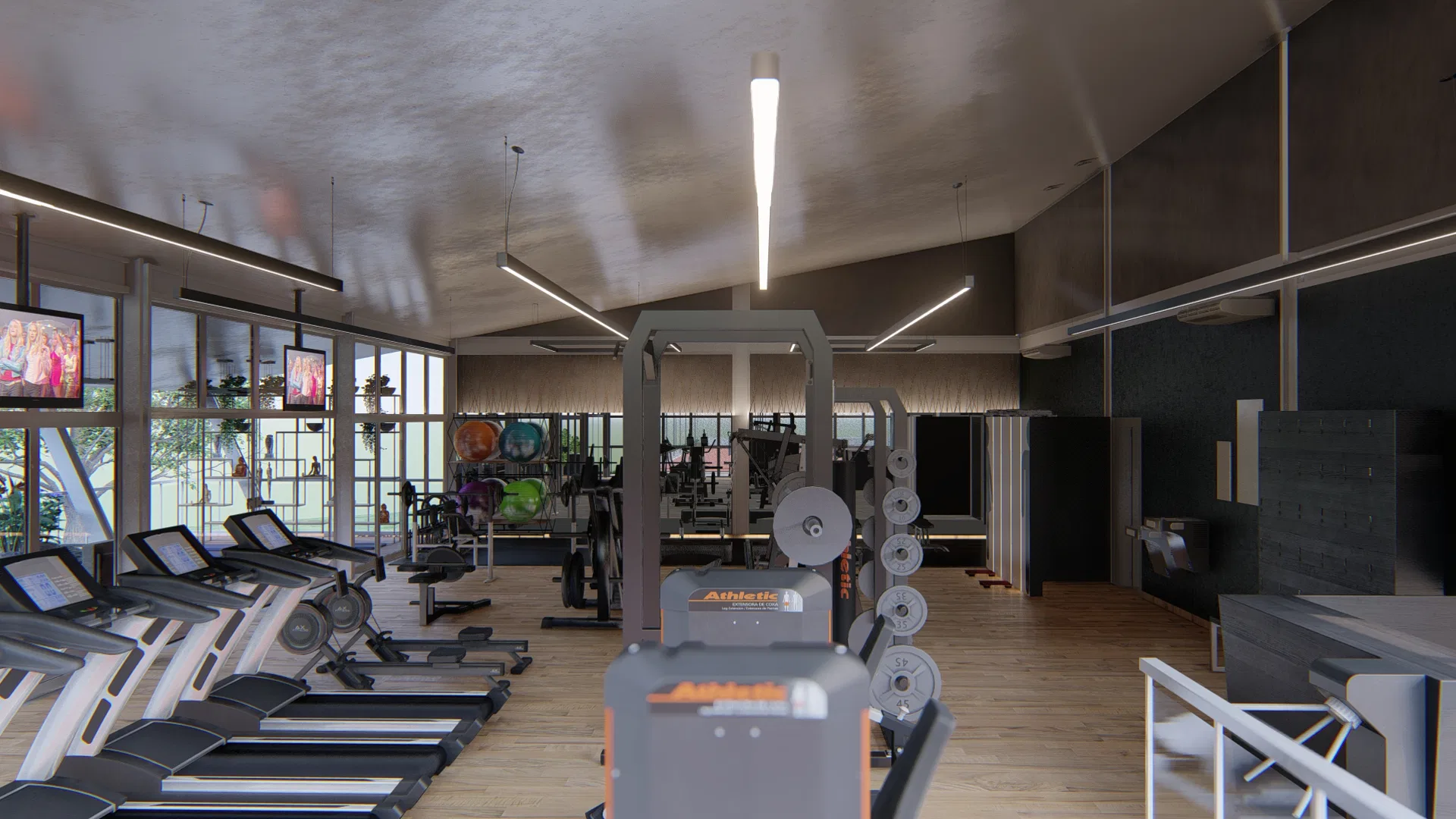 Salão de treino com fileira de esteiras junto às janelas, televisores na parede, equipamentos de musculação, piso de madeira e teto inclinado com luz linear