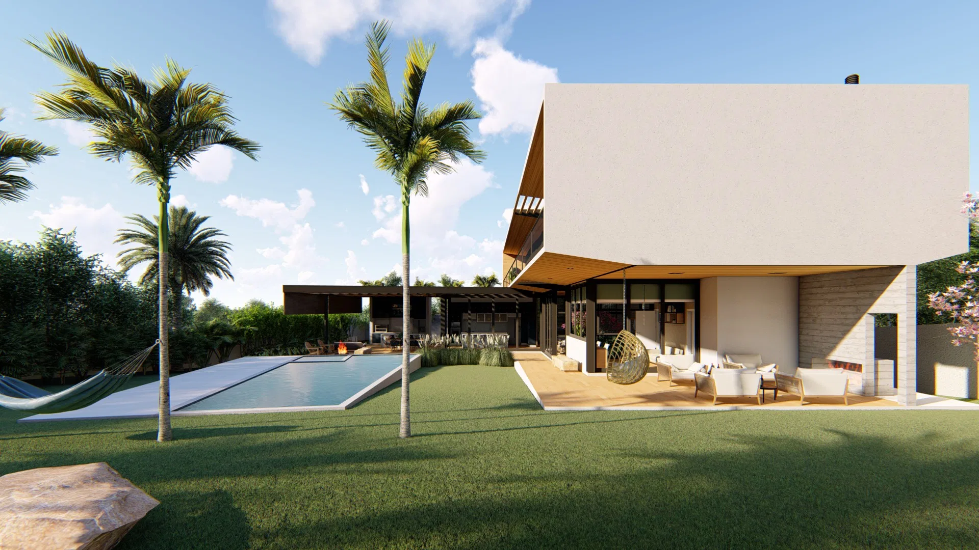 Fundos da residência com volume superior em balanço, terraço coberto de estar com poltronas e cadeira-ovo suspensa, piscina alongada e palmeiras
