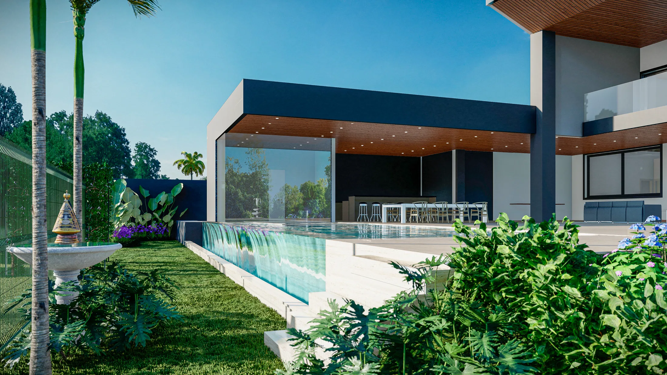 Piscina de borda vidrada ao lado de área de estar coberta com forro de madeira, bancada e banquetas atrás do vidro, jardim com fonte e palmeiras