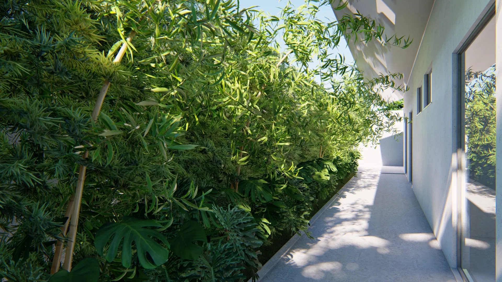 Corredor lateral estreito margeado por densa vegetação de bambu e folhagens, com caminho branco iluminado ao longo da fachada