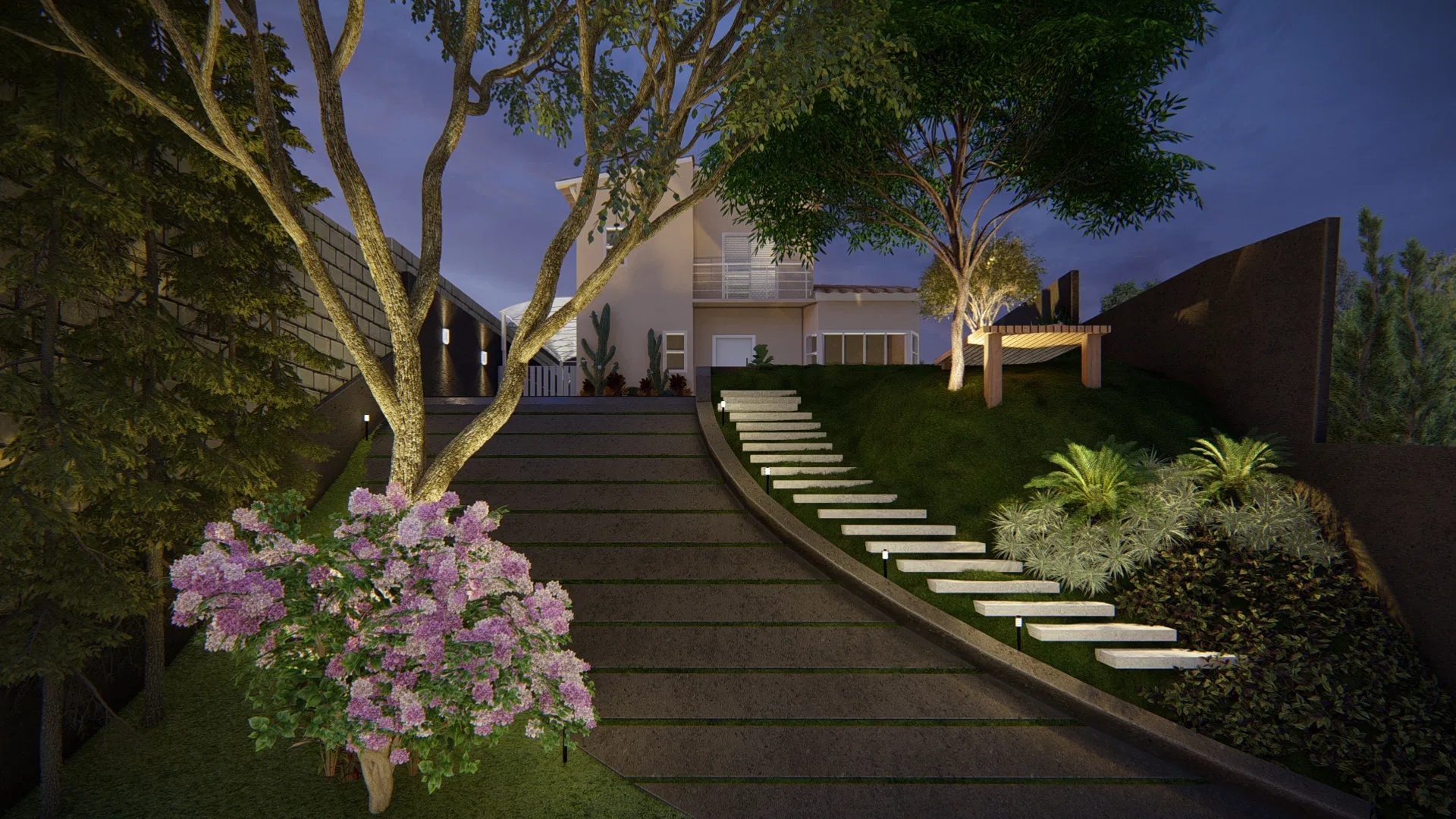 Jardim em aclive ao anoitecer, com longa escadaria subindo o talude gramado, árvore florida em primeiro plano e a casa iluminada no topo do terreno